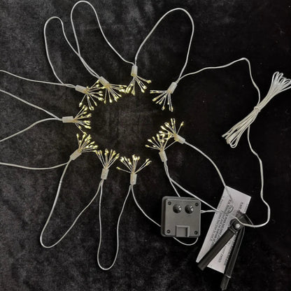 Dandelion-shaped string lights in a circular arrangement, with a solar panel and instructions.
