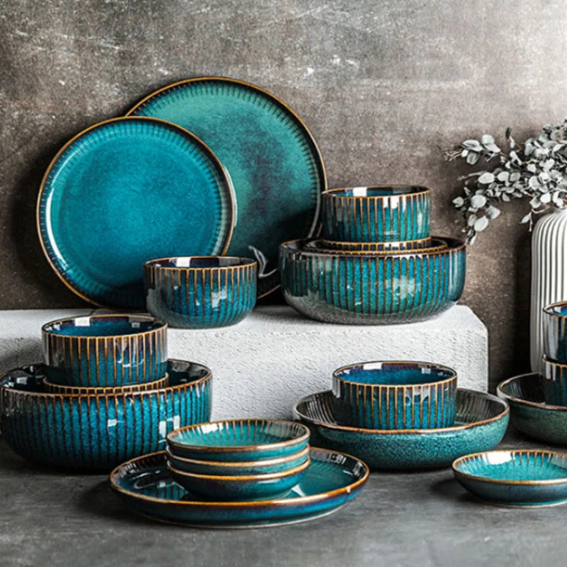 A comprehensive collection of blue ceramic dinnerware, featuring various plates and bowls, arranged on different levels.
