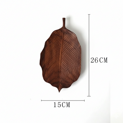 A brown, leaf-shaped wooden decorative tray or dish, with dimensions marked as 26 CM in height and 15 CM in width, set against a plain white background.
