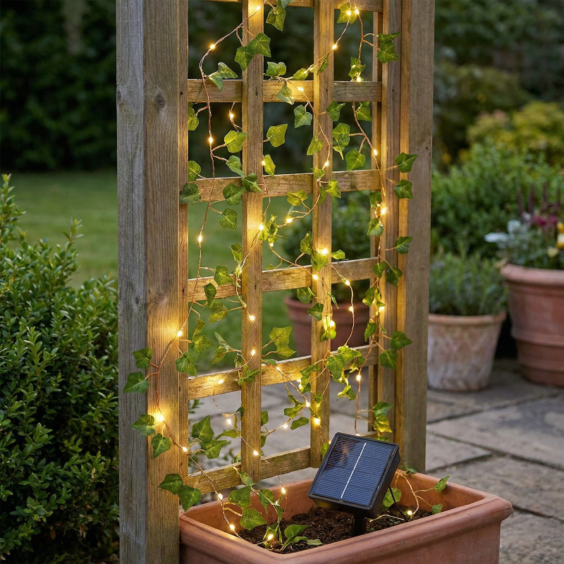 Decorative trellis with string lights and solar panel in a garden setting