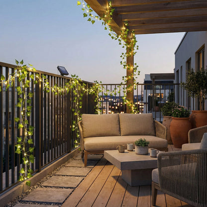 Cozy outdoor patio with a couch, coffee table, and string lights on a wooden deck.