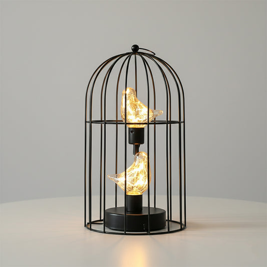Decorative lamp with birdcage design and glowing bulbs on a neutral background