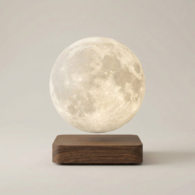 Levitating moon lamp on a wooden base against a plain background