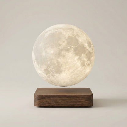 Levitating moon lamp on a wooden base against a plain background