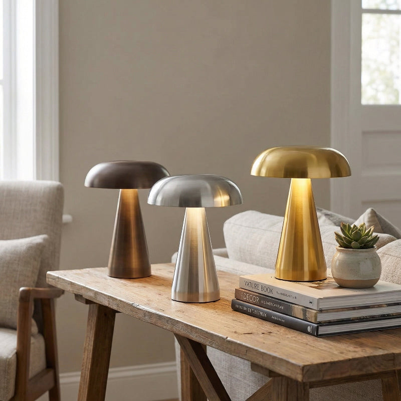 Metallic mushroom table lamps in silver, black, and gold on tray table