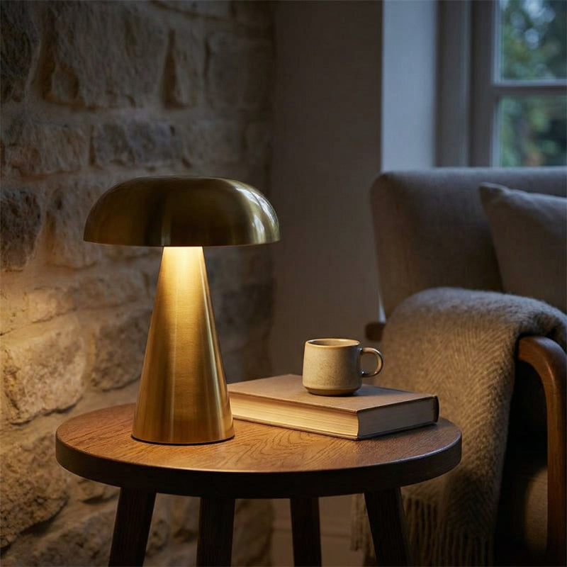 Metallic mushroom table lamp in gold on side table in warm interior