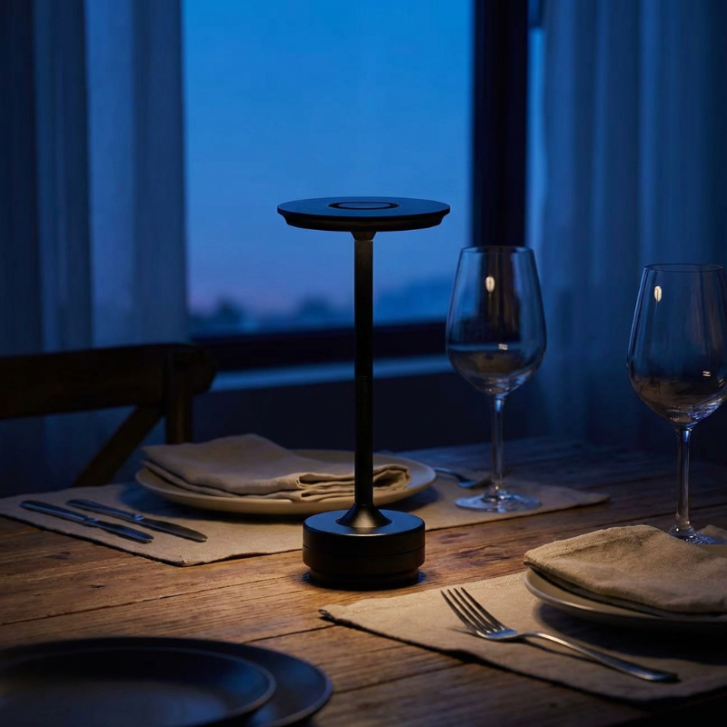 Table setting with a black lamp on a wooden table at night