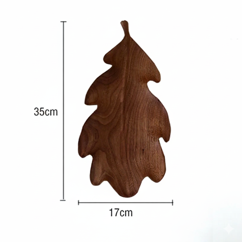 A dark brown wooden decorative tray or dish shaped like a lobed oak leaf, with dimensions marked as 35 CM in height and 17 CM in width, set against a plain white background.