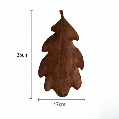 A dark brown wooden decorative tray or dish shaped like a lobed oak leaf, with dimensions marked as 35 CM in height and 17 CM in width, set against a plain white background.