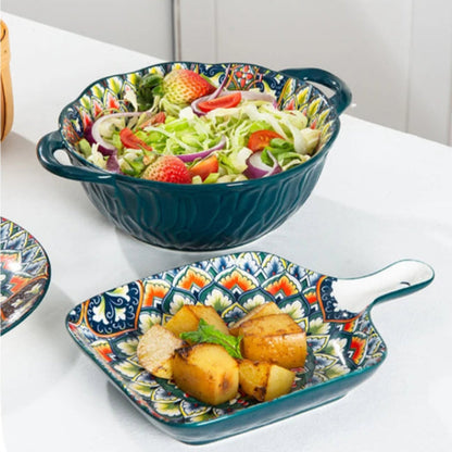 A serving of salad and a small plate of roasted potatoes.