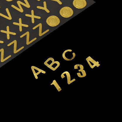 Gold letter and number stickers on black.