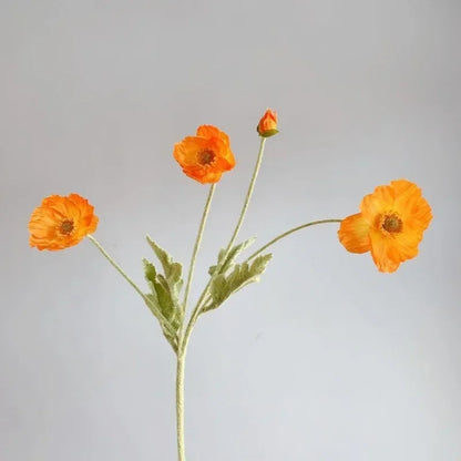 Three vibrant orange poppy flowers with green stems and one poppy bud are arranged in a sparse bouquet against a plain light grey background.