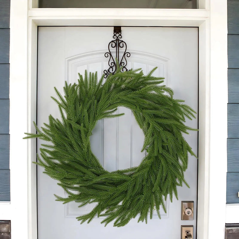 A simple green wreath on a white door.