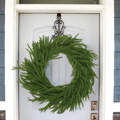 A simple green wreath on a white door.