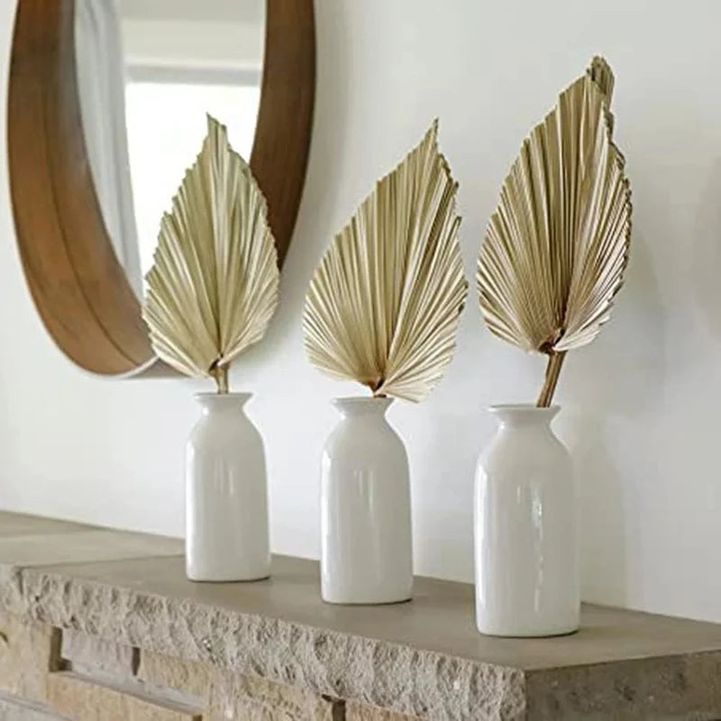 Palm fan leaf decor styled on a console table, adding natural boho charm to a modern living room.