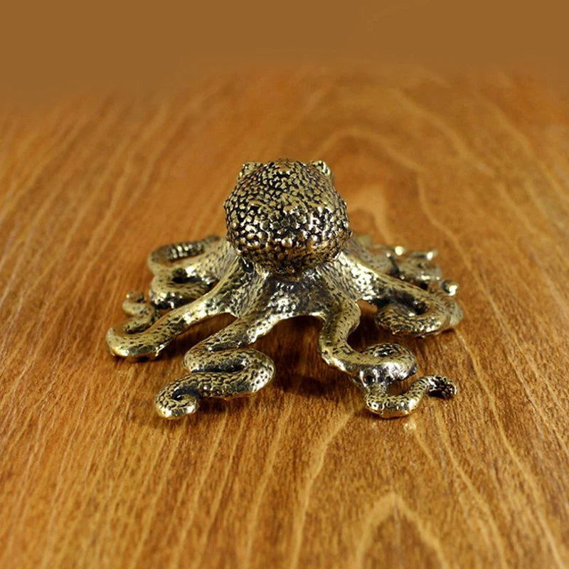 Bronze octopus figurine on a wooden surface