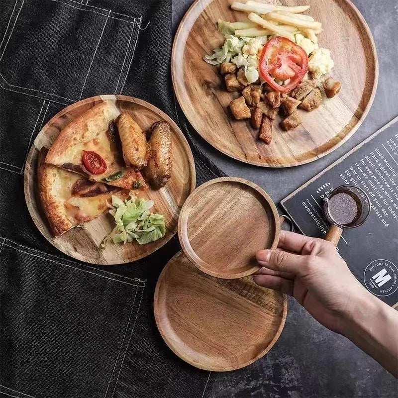 Wooden plates with food on a gray surface