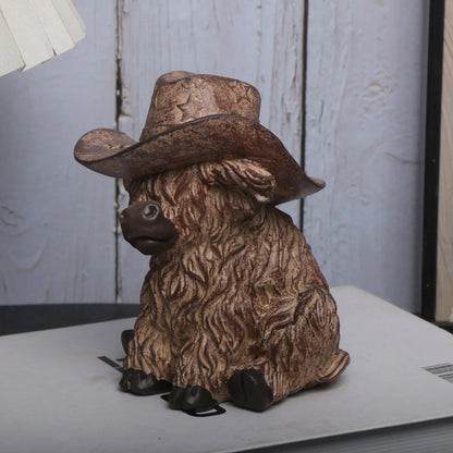 Decorative figurine of a sheep wearing a cowboy hat on a surface with a light gray background.