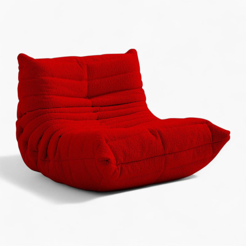 Red modern lounge chair with white background.