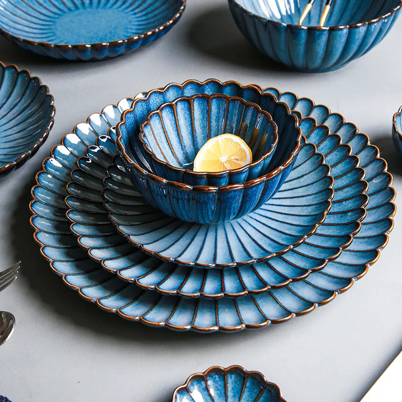 A stack of blue ceramic dishes with a lemon slice in the top bowl.