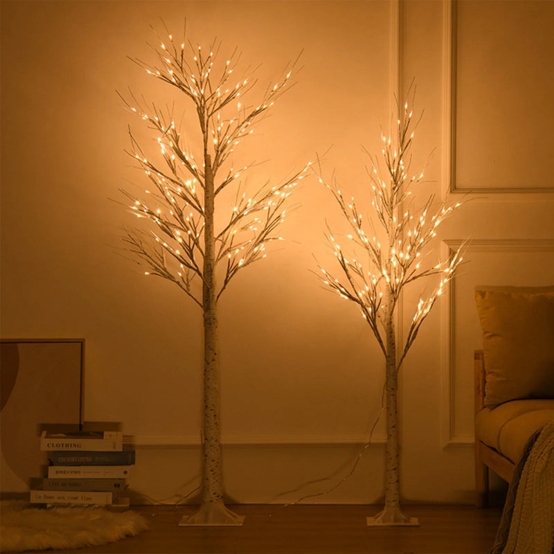 Two illuminated decorative trees in a room with warm lighting.