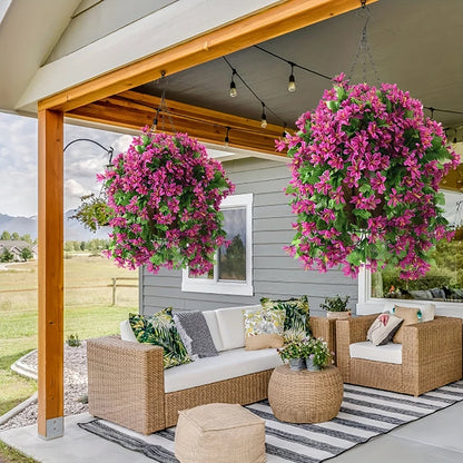 Outdoor patio with rattan furniture and two large hanging baskets of pink faux flowers.