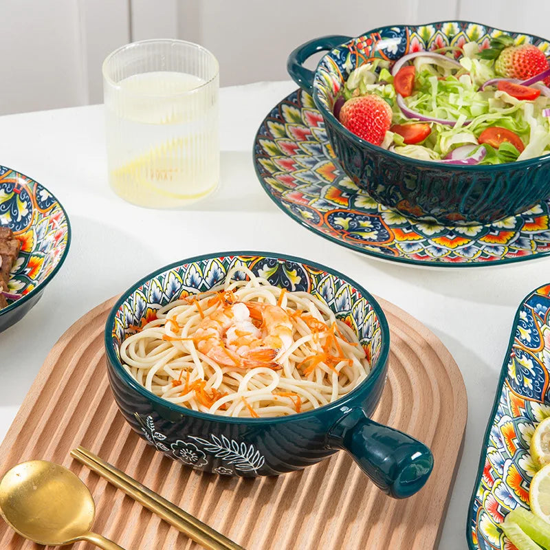 A bowl of noodles with shrimp and carrots on a wooden tray, next to a bowl of salad.