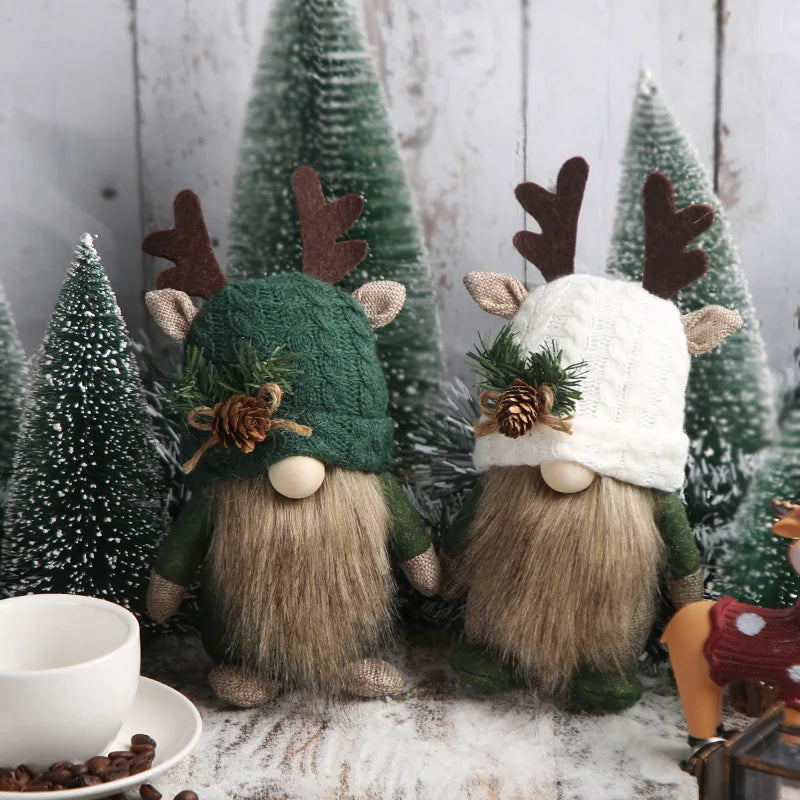 Two festive gnomes with winter hats and antlers in a snowy scene with small trees.