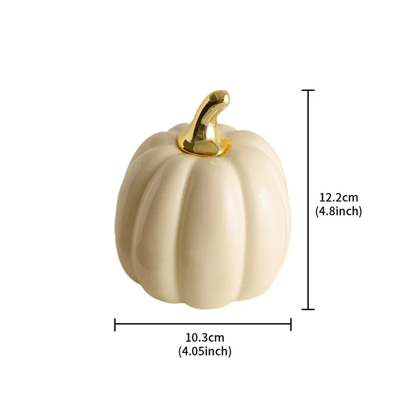 A cream-colored ceramic pumpkin with a gold stem is shown with its dimensions: 10.3cm (4.05 inches) wide and 12.2cm (4.8 inches) tall.