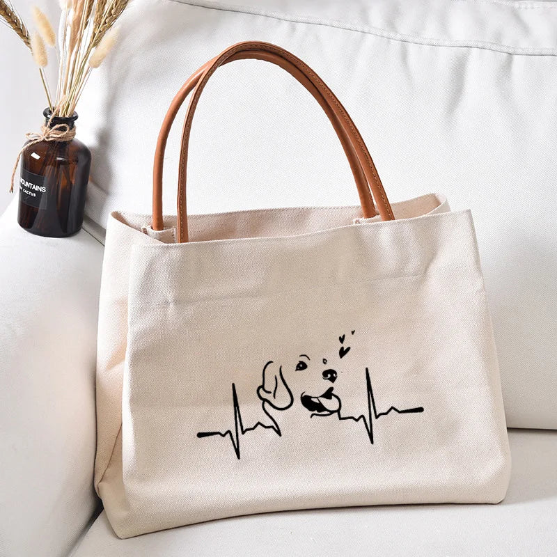 Canvas tote bag with a dog and heartbeat graphic.