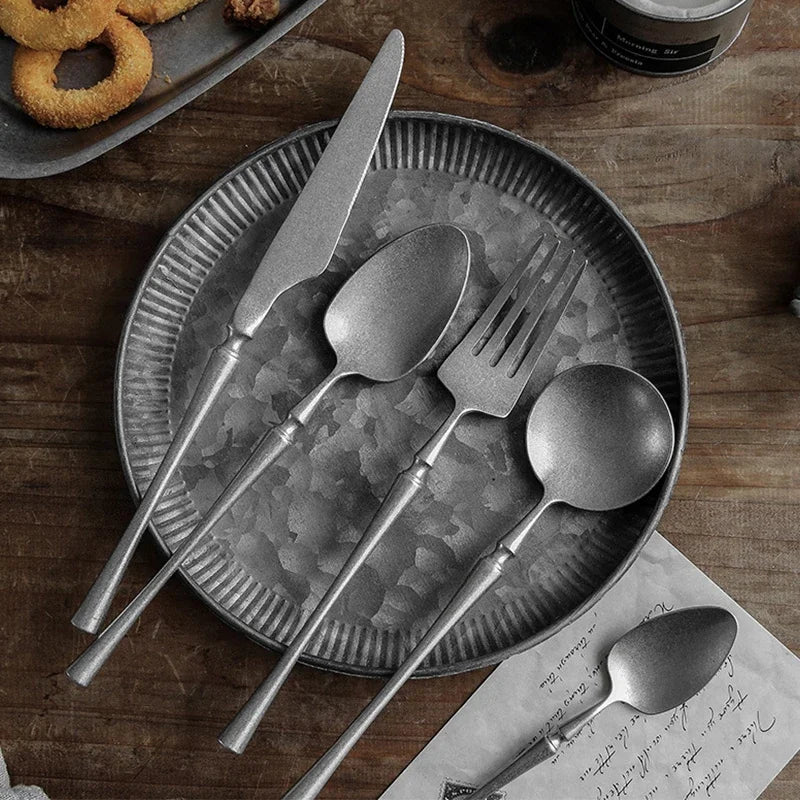 Rustic silverware on metal plate