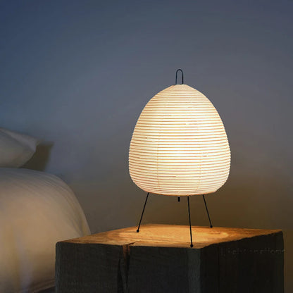 Akari lamp placed on a side table or desk, adding a touch of minimalist Japanese design and creating a peaceful retreat in the room.