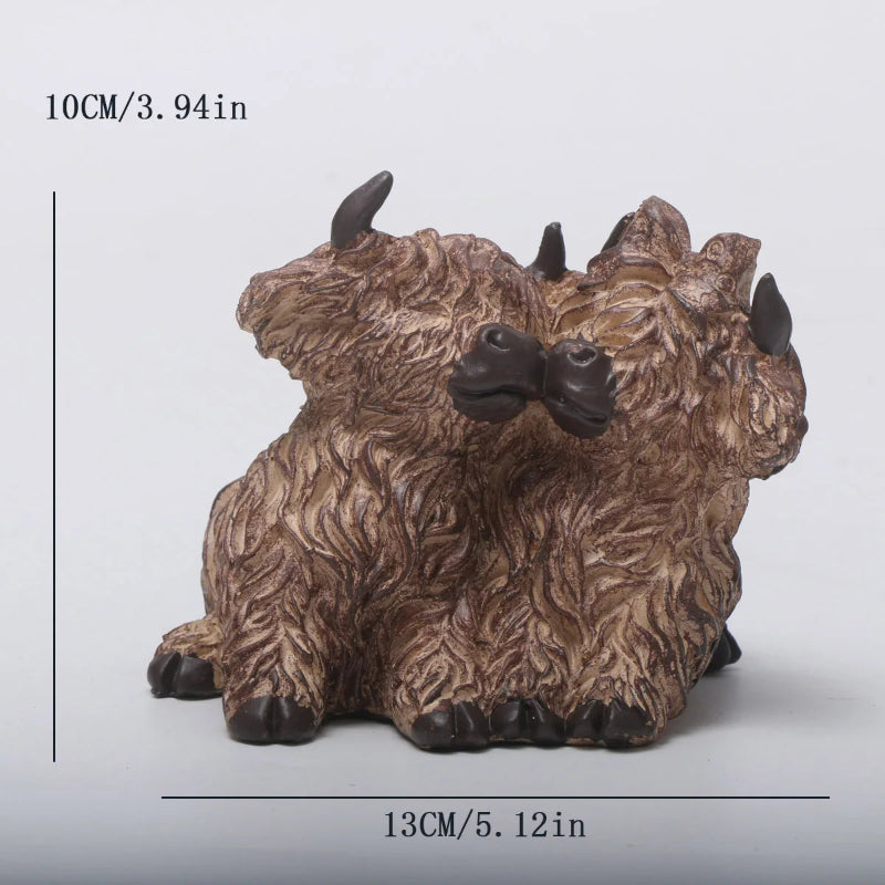 Small brown and black bison figurine with measurements on a light gray background
