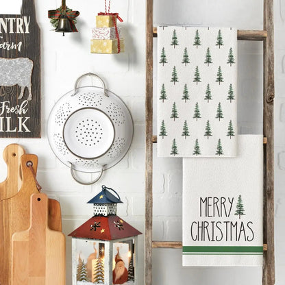 Decorative kitchen scene with Christmas-themed towels, lantern, and wooden signs.