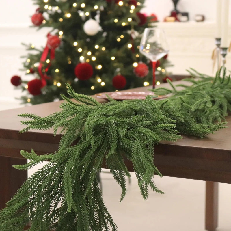 Green table runner on a wooden table with a decorated Christmas tree in the background.