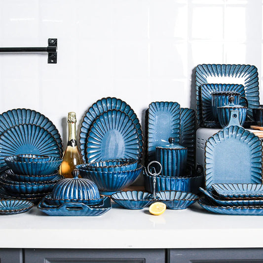 Blue dinnerware set with a champagne bottle.