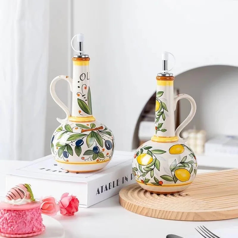 Two ceramic oil and vinegar bottles with decorative designs on a white surface.
