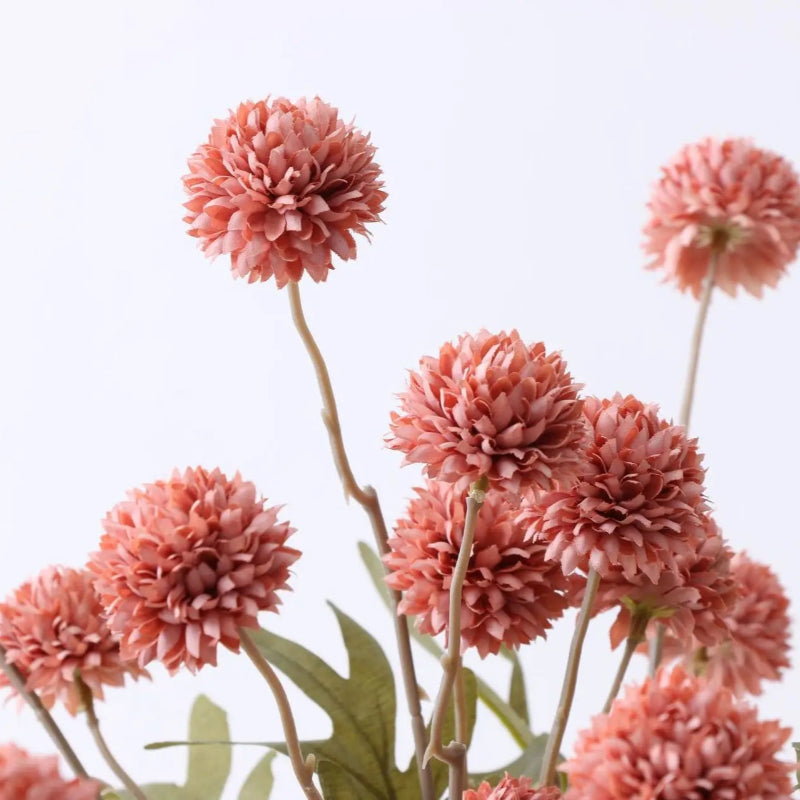 Close-up of rust-colored artificial dahlia flowers.