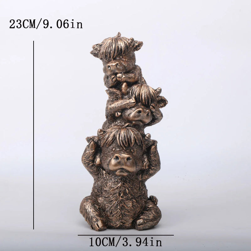 Bronze sculpture of a bear with cubs on a white background