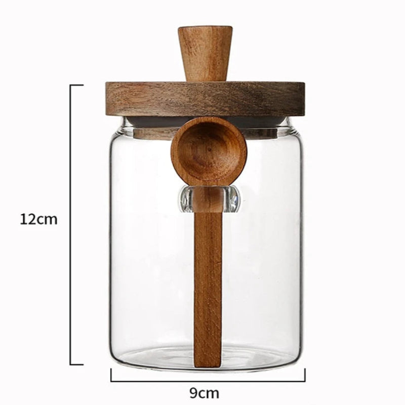 Clear glass jar with wooden spoon and lid, showing dimensions on a white background