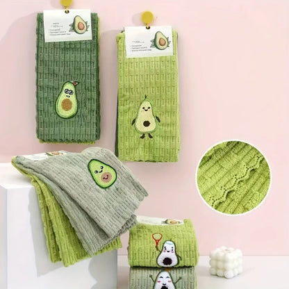 Set of green kitchen towels with avocado designs on a pink background
