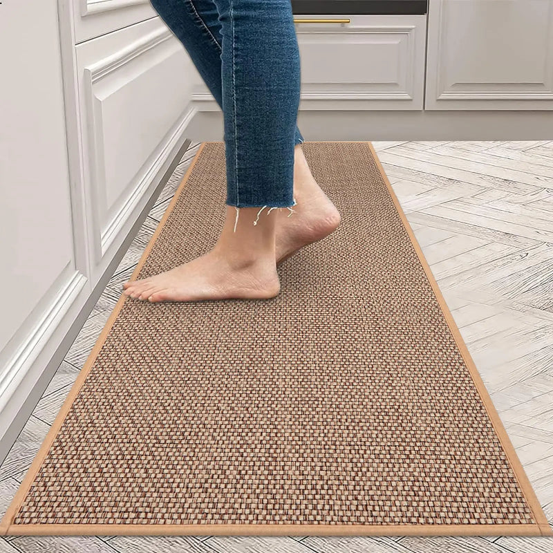 Person walking on a brown woven mat in a kitchen.