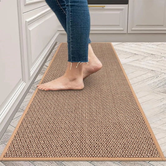 Person walking on a brown woven mat in a kitchen.