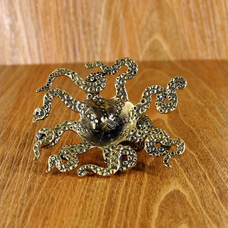 Bronze octopus decorative item on a wooden surface