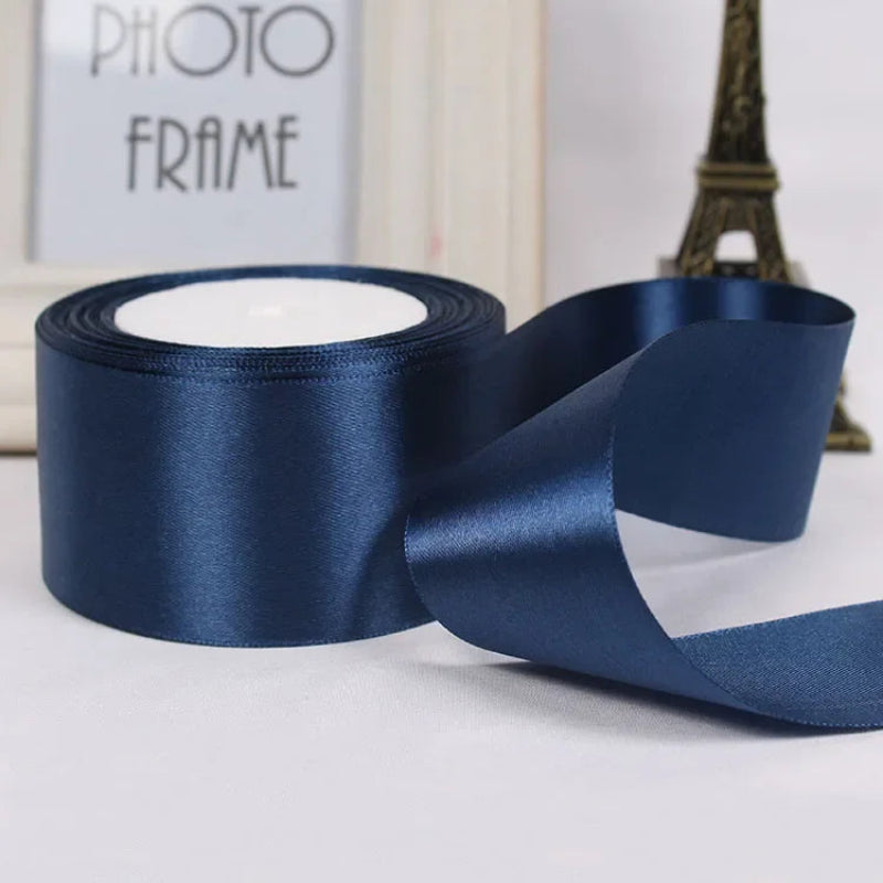 Roll of blue satin ribbon with a blurred background