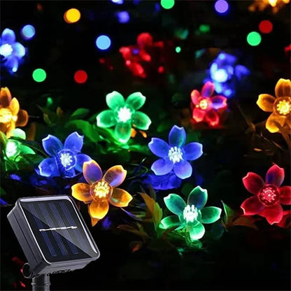 Solar-powered multicolored LED flower string lights and solar panel.