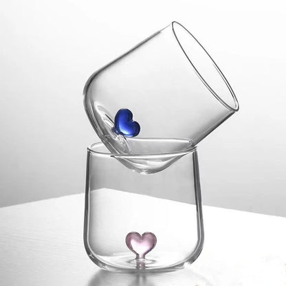 Two clear glasses with heart-shaped bottoms.