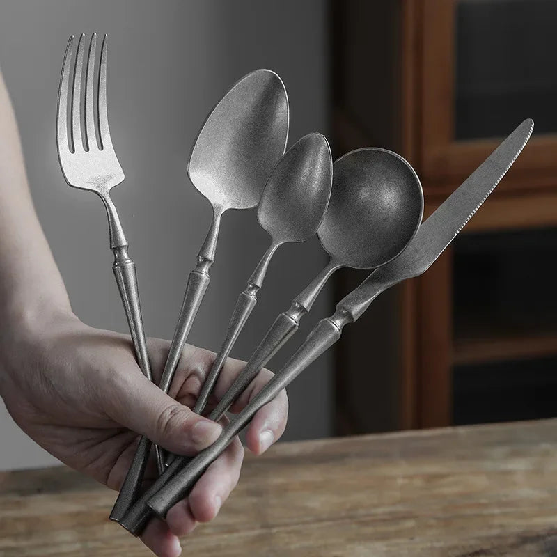 Hand holding antique-style silverware