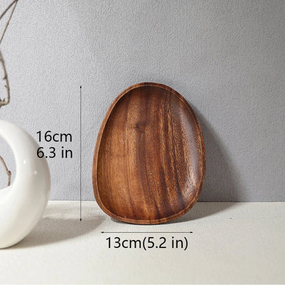 Asymmetrically shaped wooden serving tray with dimensions: 16 cm (6.3 in) long and 13 cm (5.2 in) wide.