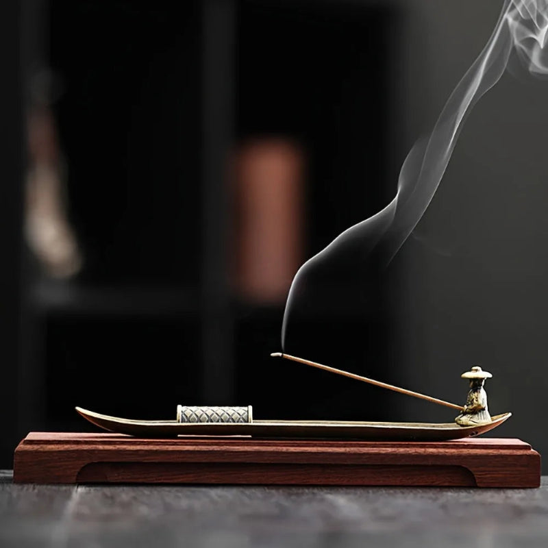 Incense stick with smoke rising from a wooden holder on a dark background